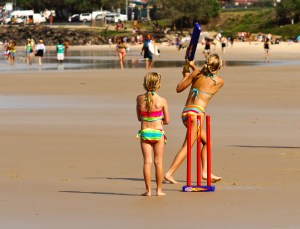 A family plays beach cricket at Byron Bay
